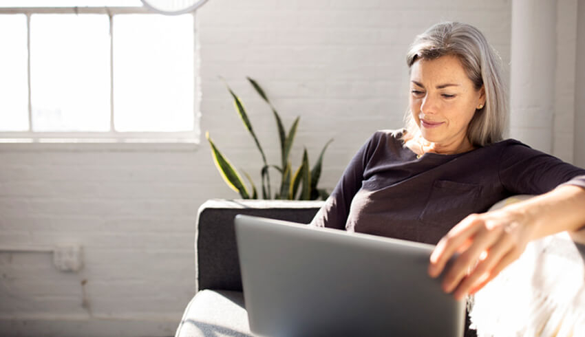 A woman works on a laptop 